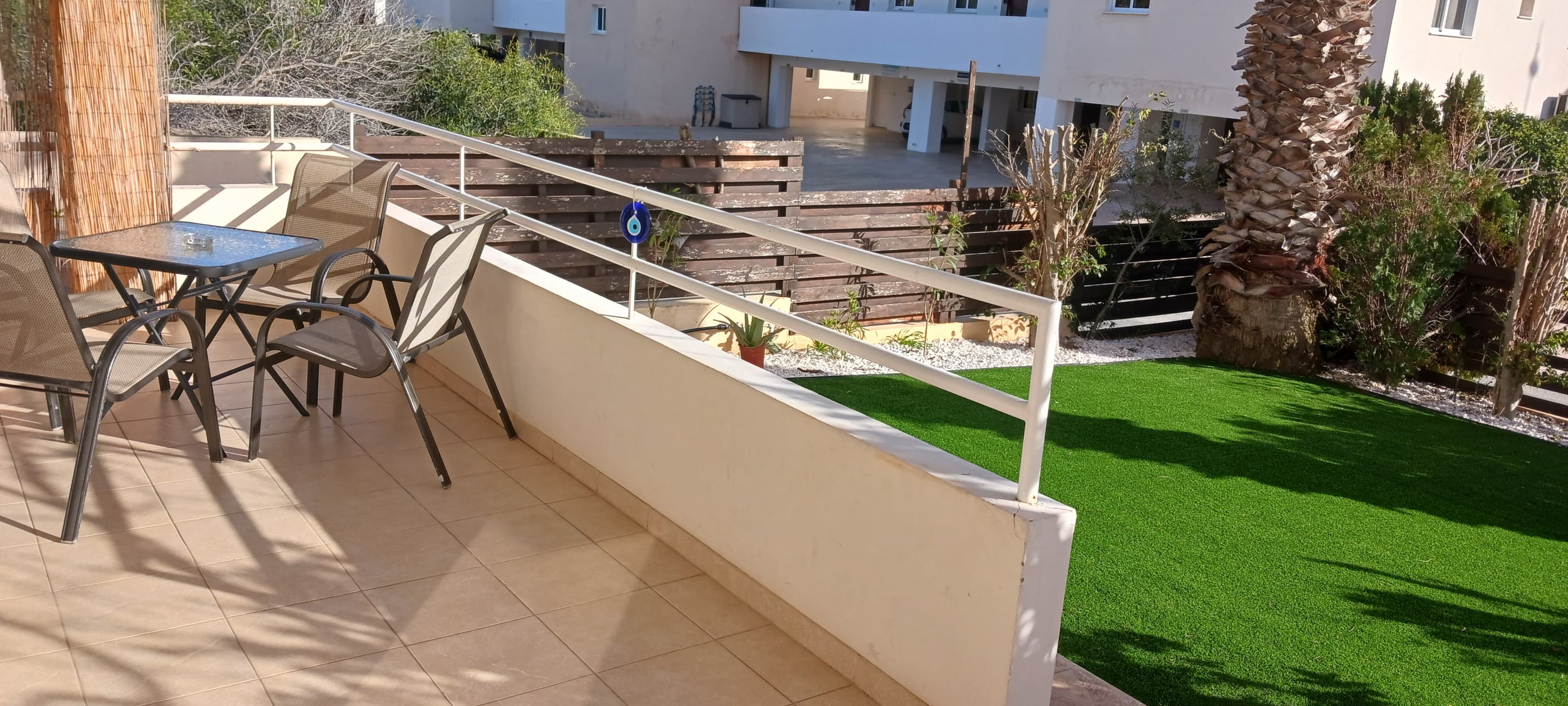 Covered terrace beside the private garden at the Nissi 3 apartment
